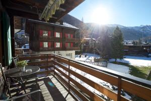 a balcony with a table and a view of the mountains at Chalet Felderhof in Zermatt