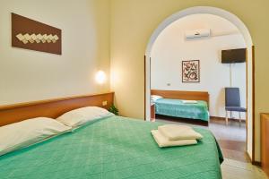 Postel nebo postele na pokoji v ubytování G/Hotel Lignano