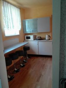 a kitchen with a counter and stools in a room at Gästezimmer Fuchs in Neuhausen auf den Fildern +14 photos