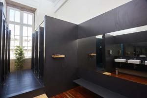 a bathroom with two sinks and a large mirror at The Passenger Hostel in Porto