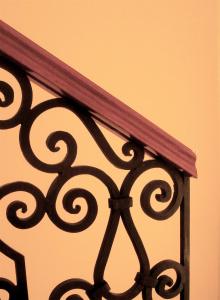 a close up of a metal fence with a wooden rail at Scala Hotel in Lagos de Moreno