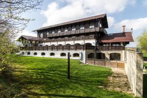 a large building on top of a green field at Pensiunea Gentiana in Bran
