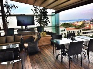 a balcony with a television and tables and chairs at Burckin Hotel in Istanbul
