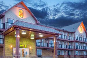 a large building with a sign on the front of it at Super 8 by Wyndham Caraquet in Caraquet