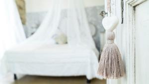 a teddy bear on a door with a tassel at Locanda Garzelli in Quercianella