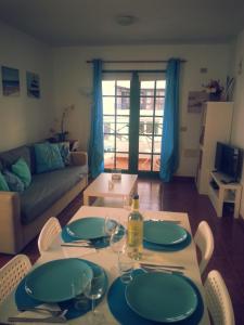a living room with a table with plates and wine glasses at La casita de Esteban in Arrieta