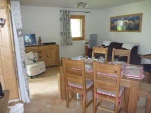 a living room with a table and chairs and a bedroom at R&eacute;sidence Les Chardons Argent&eacute;s 2 in Samo&euml;ns