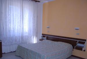 Postel nebo postele na pokoji v ubytování Hotel Vittoria