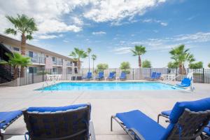 a swimming pool with lounge chairs and a hotel at Days Inn by Wyndham Lake Havasu in Lake Havasu City