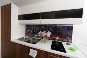 a kitchen with a view of a city skyline at Studio Optim in Ljubljana