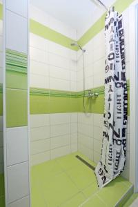 a shower with a shower curtain in a bathroom at Studio Optim in Ljubljana