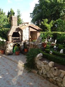 a stone oven in a garden with plants at Colic in Crikvenica