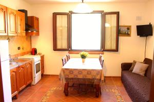 a small kitchen with a table and a window at Casale Orioles in Torretta +56 photos