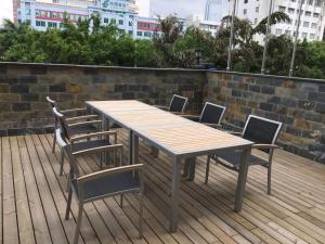 a wooden table and chairs on a wooden deck at Jinjiang Inn Nanning Chaoyang Square People's Park in Nanning