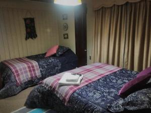 Ein Bett oder Betten in einem Zimmer der Unterkunft Hostal Los Guindos
