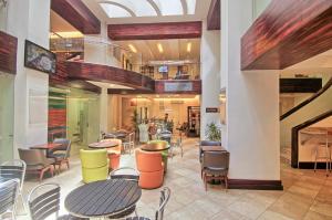 a restaurant with tables and chairs in a building at Balmoral Hotel San José CR, Historic District in San José
