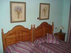 1 dormitorio con 1 cama y 2 cuadros en la pared en Hotel Restaurante el Horno en La Puebla de Valverde