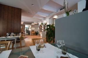 a dining room with a table with wine glasses on it at Borgo del Faro in Fano