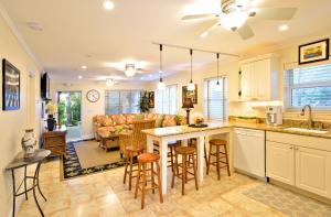 a kitchen and living room with a table and chairs at Center Court-Boutique Old Town Lodging in Key West