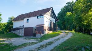 an old stone house on a dirt road at Holiday Home Radočaj in Slunj