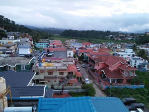 an aerial view of a town with houses at Suroor Tourist Home in Virajpet