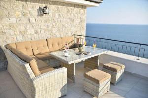 a patio with a couch and a table and chairs at Hotel Pirate Old Town in Ulcinj
