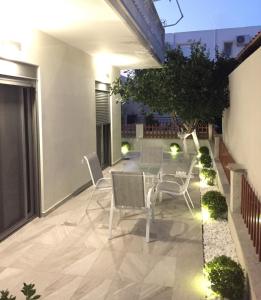 a patio with chairs and a table on a balcony at Lardos Luxury Apartments in Lartos