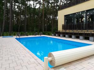 a swimming pool in front of a building at Wrzosowy Resort Pogorzelica Apartament SREBRNY Sea&Forest in Pogorzelica +17 photos