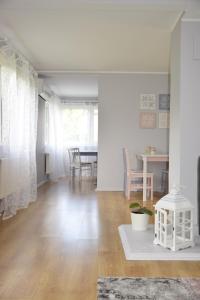 a living room with a table and a dining room at Esplanaadi Villa in Pärnu