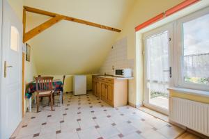 a small kitchen with a table and a window at Agroturystyka Pod Podkową in Mrągowo +84 photos