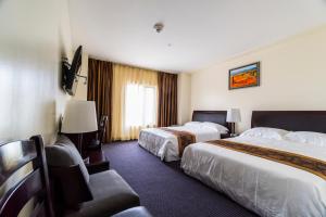 Postel nebo postele na pokoji v ubytování John Hotel