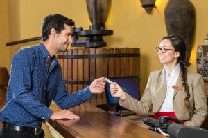 a man and a woman sitting at a table talking at Hotel Santa Cruz Plaza in Santa Cruz +54 photos