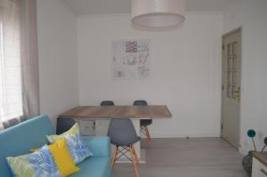 a living room with a blue couch and a table at Modern and Cozy Apartment in Vila Nova de Gaia