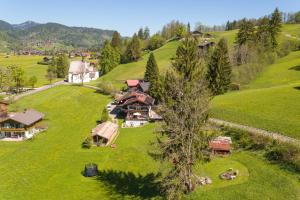 an aerial view of a house on a green field at Hütte Almrausch in Oberstdorf