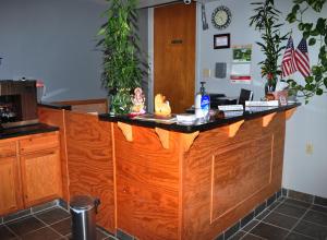 a kitchen with a wooden counter top with plants at Bestway Inn in Ruidoso Downs