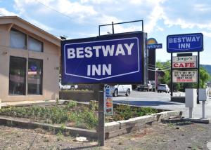 a sign for a bestway inn in front of a building at Bestway Inn in Ruidoso Downs