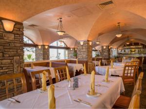 a dining room with white tables and chairs at Aquarius Casino Resort in Laughlin