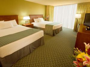 A bed or beds in a room at Aquarius Casino Resort