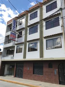 an apartment building on the corner of a street at Hostal Bond in Huaraz