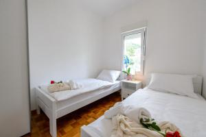 Postel nebo postele na pokoji v ubytování APARTMENT ANA 4+2
