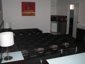 a hotel room with a bed and a table at Gympie Muster Inn in Gympie