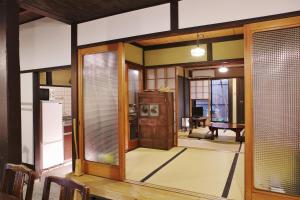 uma sala de estar com uma porta aberta para uma cozinha em Komachiya em Quioto