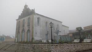 an old church with benches in front of it at Agro Villa in Areia