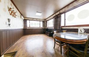 an empty room with a table and some windows at Venus Motel in Boryeong