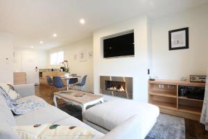 sala de estar con sofá y chimenea en The Lodges At Transport World en Invercargill