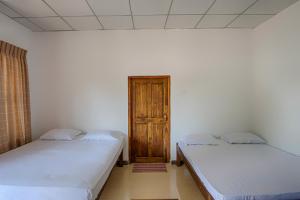 Postel nebo postele na pokoji v ubytování Wilpattu Holiday Home