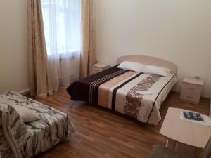 a bedroom with a bed and a desk at Parnas in Gorno-Altaysk