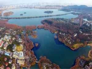 an aerial view of a river with a city at Yurong West Lake Cottage Resort Hotel Hangzhou in Hangzhou