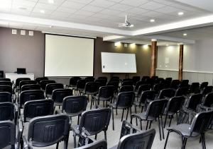 an empty room with chairs and a white screen at Skif HOTEL & SPA in Petropavlovsk +48 photos