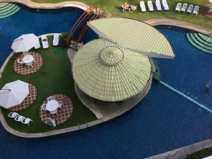 eine Aussicht über einen Pool mit Sonnenschirmen und Tischen in der Unterkunft Wild Orchid Resort in Angeles